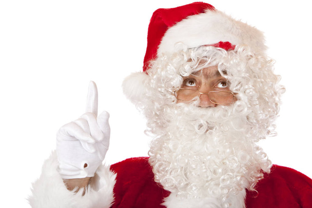 Santa Claus is pointing with his finger to the top - Φωτογραφία, εικόνα