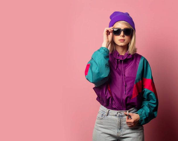 Beautiful blonde woman in sunglasses and 90s clothes  - Photo, image
