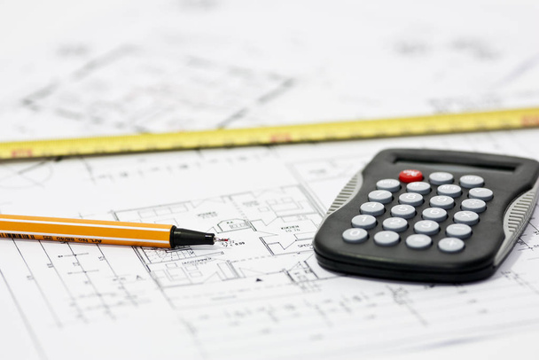 construction plans with calculator and pencil - Fotó, kép