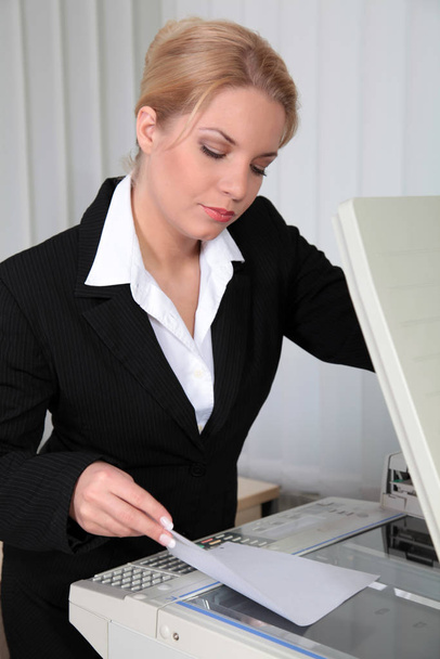 woman puts document in the copier - Fotoğraf, Görsel
