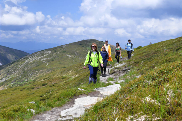 Chornohora, Ukraine  June 7, 2019: A group of tourists on a mountain trail. - Photo, Image