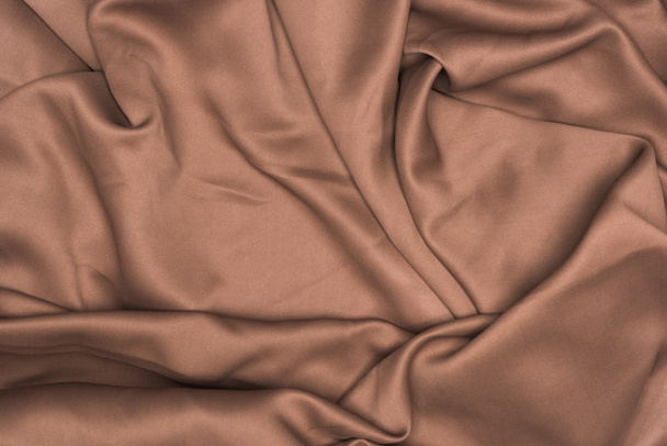 Top view of background of brown wavy satin cloth - Zdjęcie, obraz