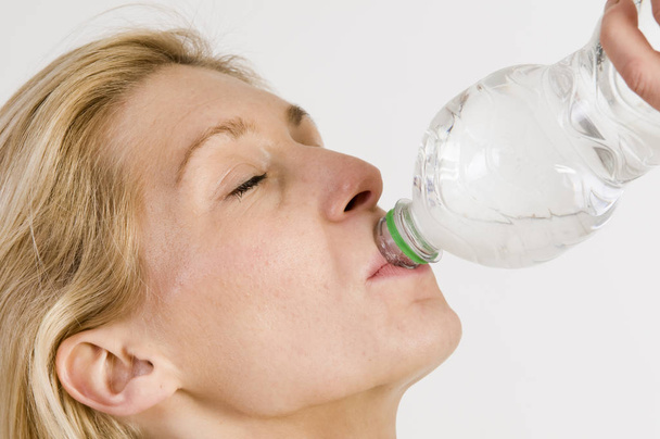 young woman drinking water from a bottle - Foto, Bild