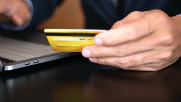 4k videó a Hands holding hitelkártya és a laptop otthoni irodai, fizetési és online vásárlási koncepció - Felvétel, videó