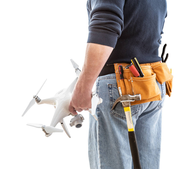 Construction Worker and Drone Pilot With Toolbelt Holding Quadcopter Drone Isolated on White Background - Photo, Image