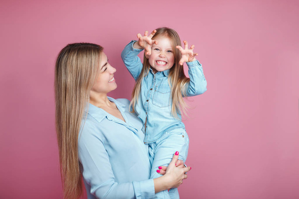Woman in blue clothes having fun with cute child baby girl - Photo, Image