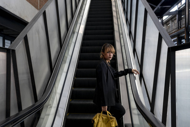 Woman on escalator. - Photo, Image
