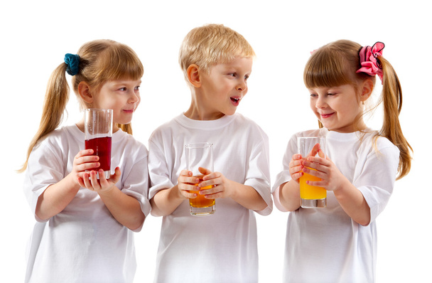 Smiling children with a glass of juice - Fotó, kép