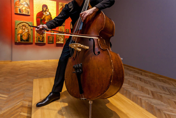 A man playing on a double bass - Fotó, kép