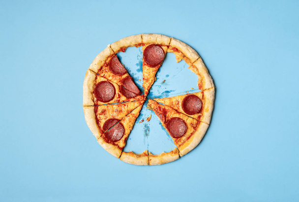 Pizza salami with missing slices and leftover crust - Fotografie, Obrázek
