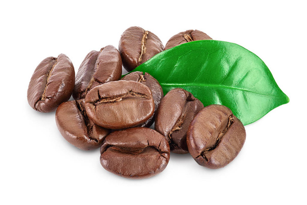 Heap of roasted coffee beans with leaves isolated on white background with clipping path and full depth of field. - Photo, Image
