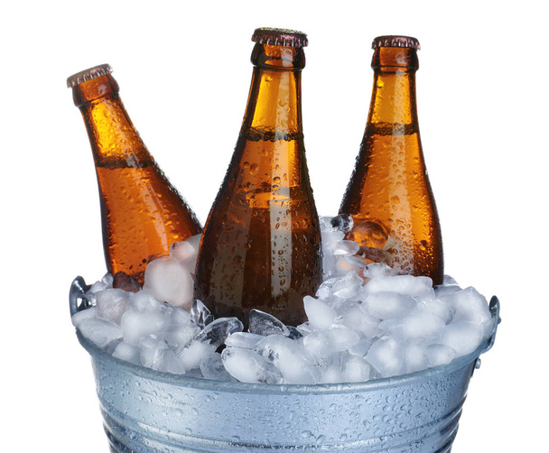 Beer in metal bucket with ice isolated on white - Photo, image