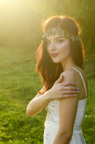 young beautiful woman in fashionable dress posing outdoors   - Фото, изображение