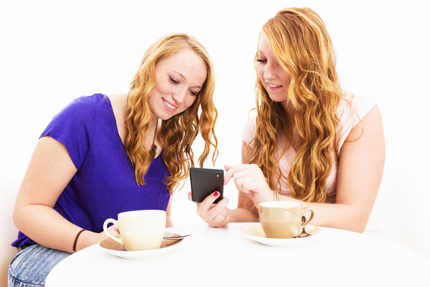 two women busy with a smartphone - Photo, Image