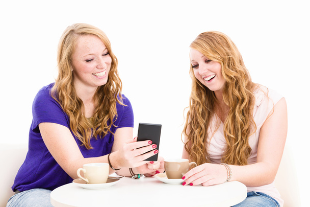 happy women looking at a smartphone - Foto, imagen