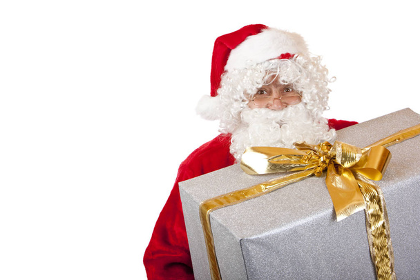 Old matured happy Santa Claus holding one big Christmas gift box - Foto, imagen