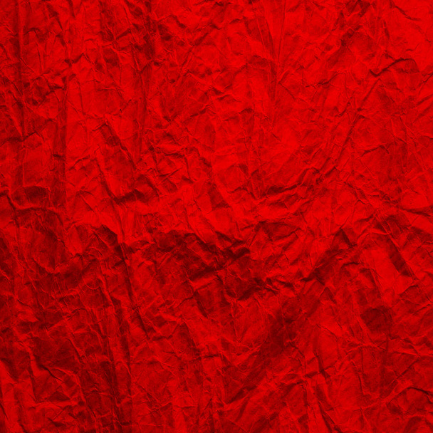Červený papír bez textu. Struktura zmačkaného papíru je červená. Pozadí recyklovaného papíru.  - Fotografie, Obrázek
