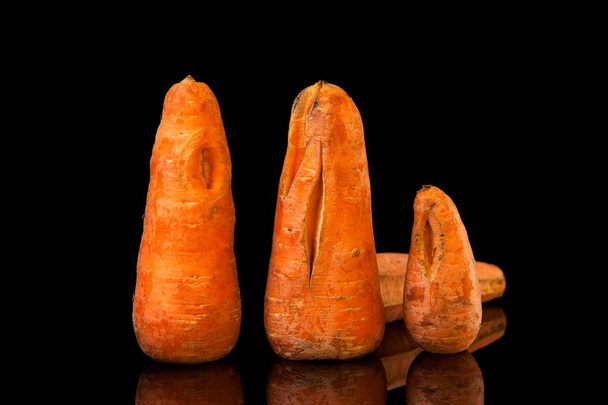 Ugly carrots on a black background. Copy space. Horizontal orien - Photo, Image