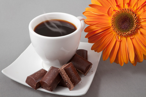 black coffee and chocolate on a background orange gerbera - Foto, Imagem