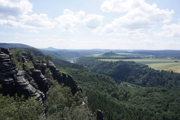 View from Schrammstein mountains over impressive landscape of Saxon Switzerland - Foto, afbeelding