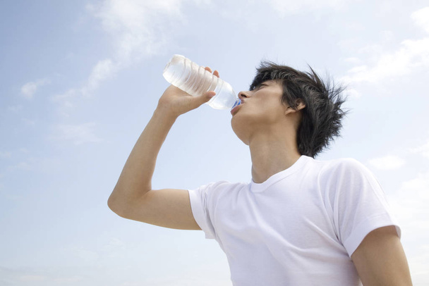 Japanese man drinking a water - Foto, Bild
