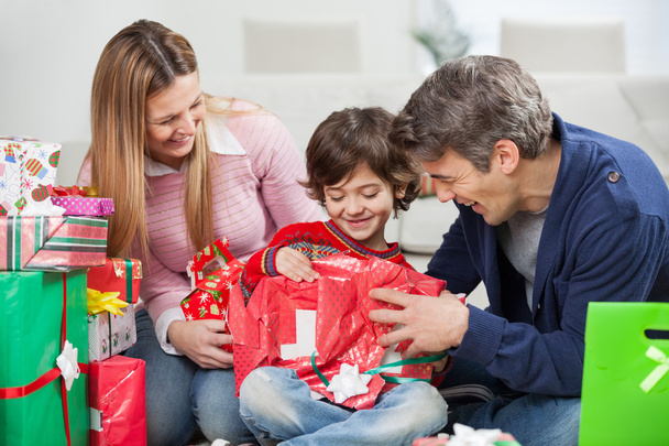 Boy And Parents Opening Christmas Present - Foto, Imagen