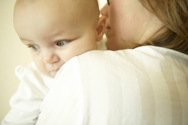 Mom holding baby. Horizontally framed shot. - Valokuva, kuva