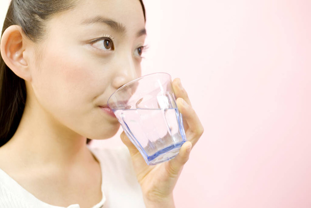 Japanese woman drinking a water - Photo, image