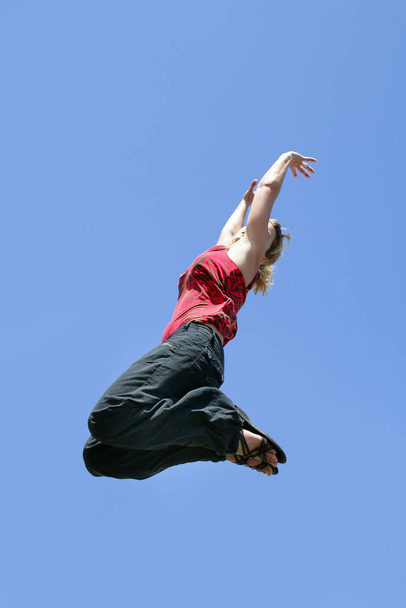 woman jumping into the air profile - Fotó, kép