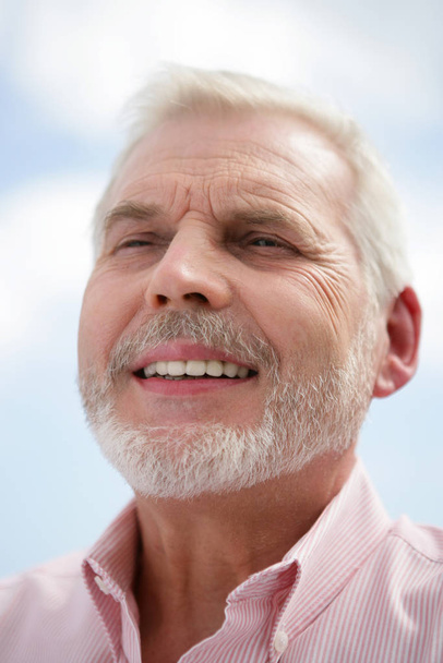 Portrait of a senior man smiling - Photo, Image