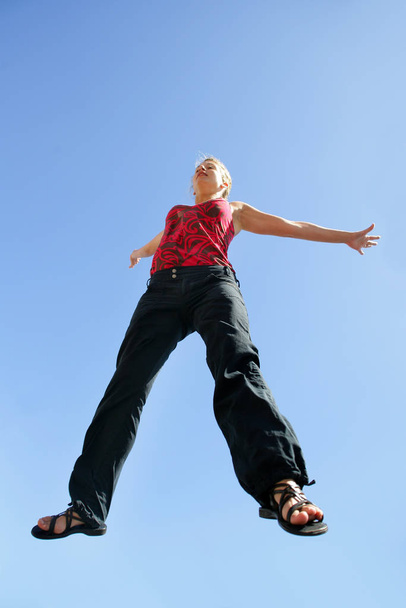 woman jumping into the air profile - 写真・画像