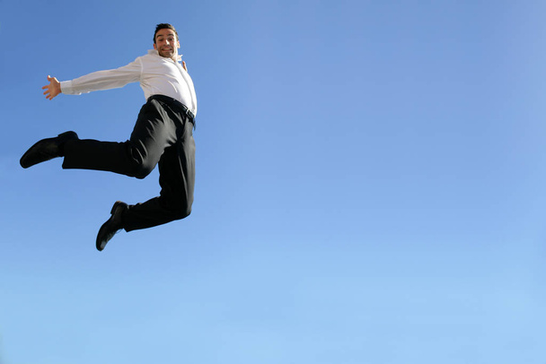 smiling man in costume leaping in the air face - Foto, imagen
