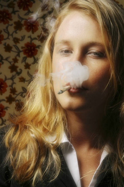 A stock photo of a woman smoking - Фото, изображение