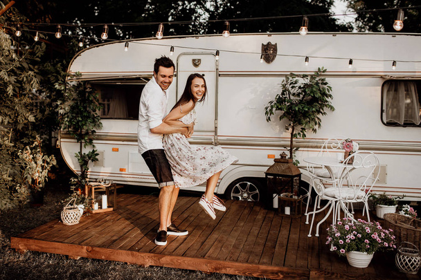beautiful young couple having fun, young people near their mobile home - Фото, зображення