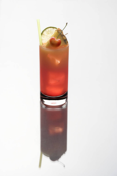 Mai Tai mixed drink with  fruit garnish on a plain white background with reflection - Φωτογραφία, εικόνα