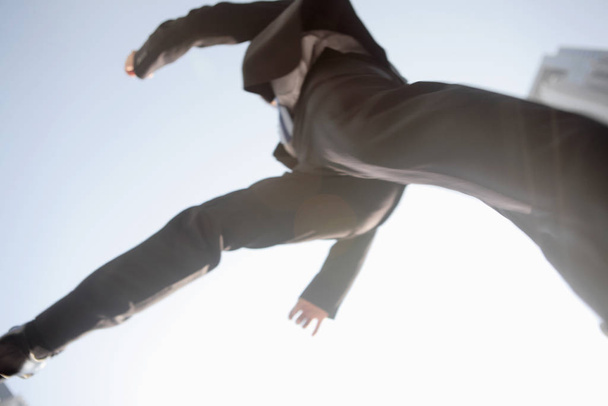 Japanese office worker jumping to the air - Фото, зображення