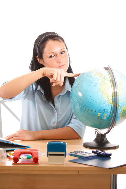 woman at desk with globe - Photo, Image