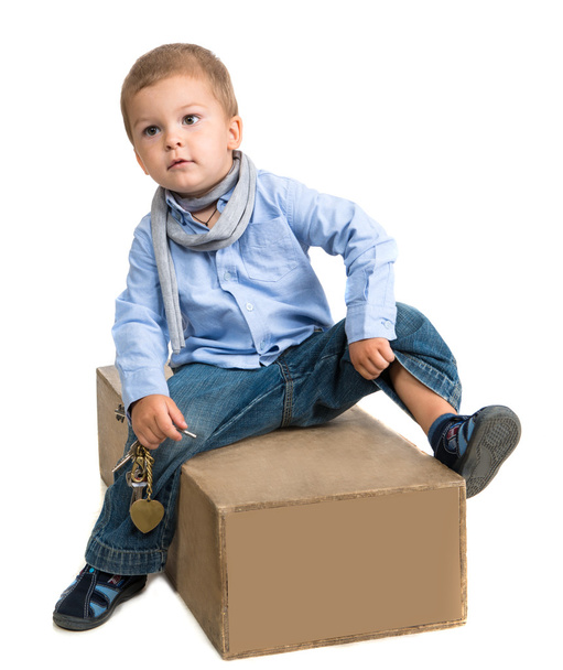Small boy sitting on a box - Foto, Imagen