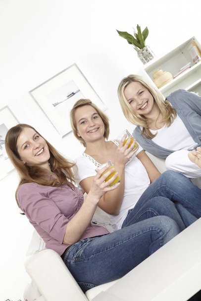 three women with orange juice - Фото, зображення