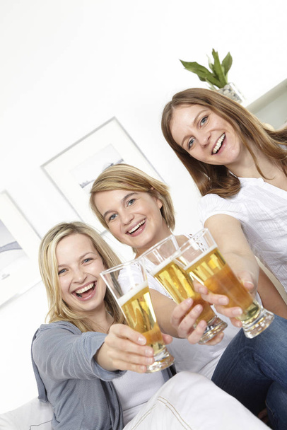three girlfriends drinking beer - Fotó, kép