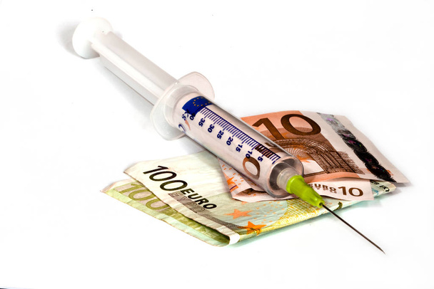 syringe with money  banknotes isolated on white - Foto, Imagen