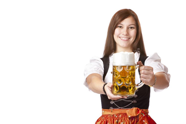 woman in dirndl holds oktoberfest beer - Фото, изображение