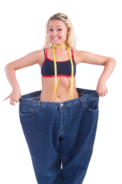 Vrouw in dieet concept met grote jeans - Foto, afbeelding