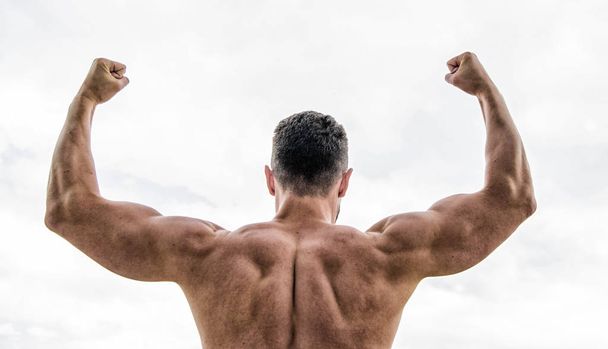 Sport motivation. Man celebrating success. Bodybuilder strong muscular back feeling powerful and superior. Achieve success. Successful athlete. Victory and success. Champion and winner concept - 写真・画像