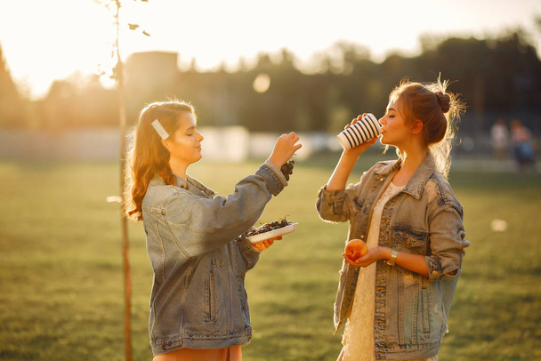 Elegant and stylish girls in a summer park - Foto, Bild