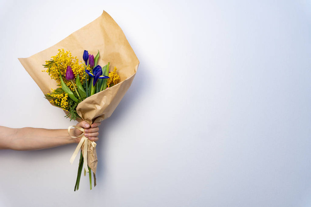 Bouquet of beautiful flowers in mans hand on white background. - Foto, Imagem