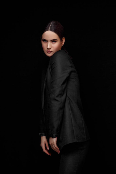High fashion expressive portrait of young elegant woman in black - 写真・画像