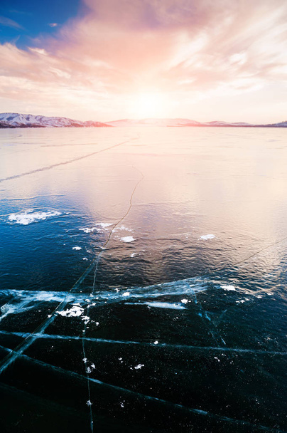 Ice on the frozen lake at sunset.  - Foto, imagen