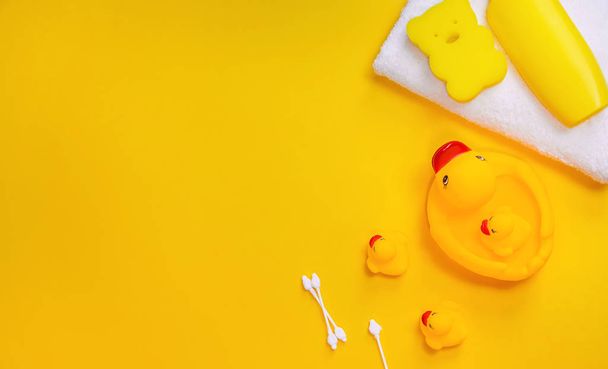 Accessories for bathing newborns on a yellow background. Selective focus. - Photo, image