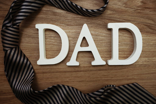 Happy Father's Day concept with DAD alphabet letter with space copy on wooden background - 写真・画像